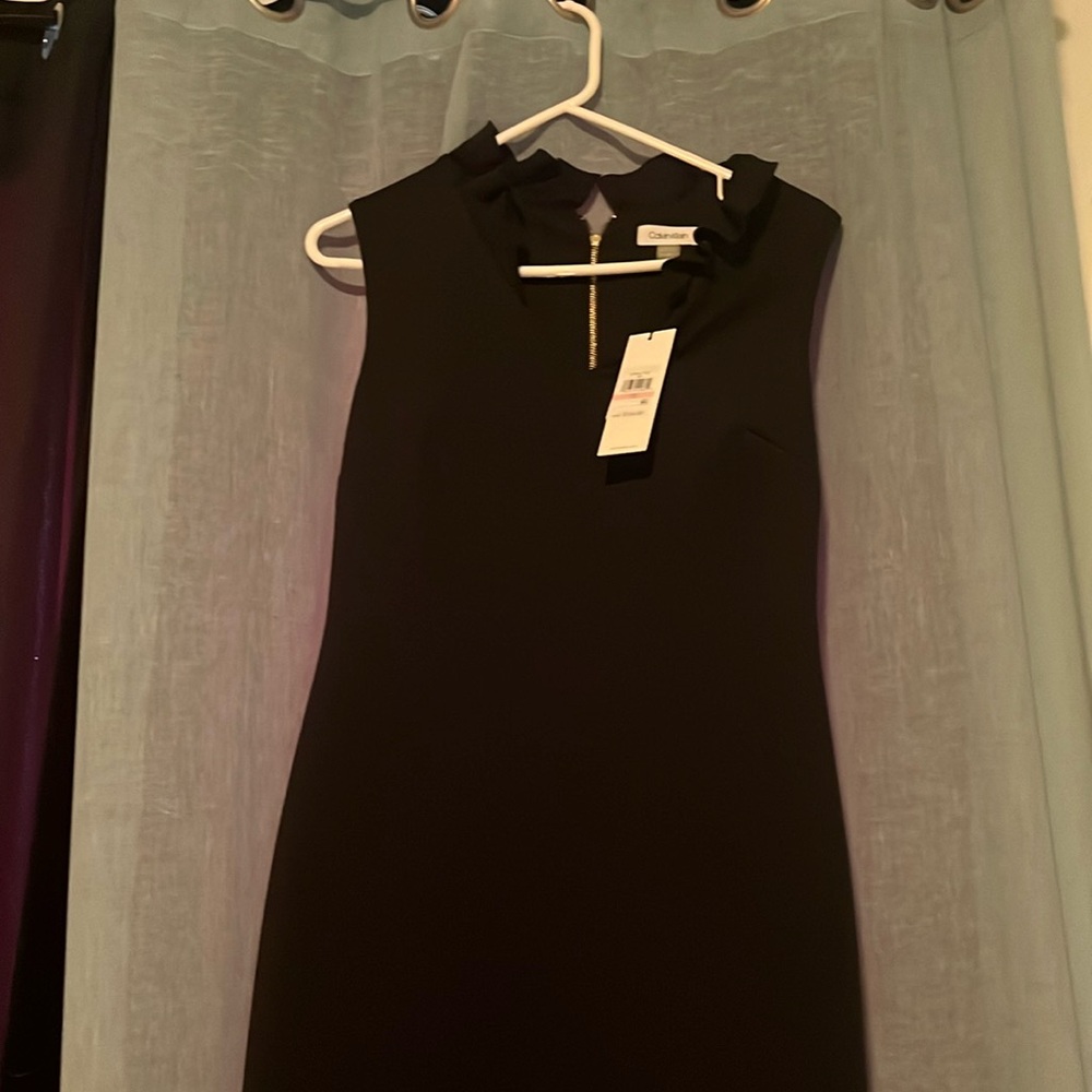 The perfect little black dress with a little ruffle at the color